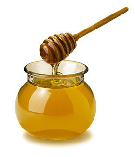 Pot of honey in use 